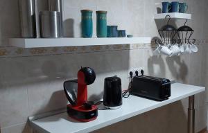a kitchen counter with a hair dryer and a toaster at Casa Arte in San José de Caideros