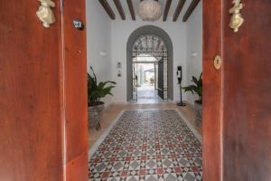 an open hallway with a tile floor and an entry way at Albariza Hotel Boutique in Sanlúcar de Barrameda