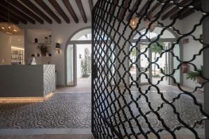 a hallway with a wrought iron fence in a house at Albariza Hotel Boutique in Sanlúcar de Barrameda