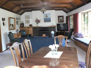 a dining room and living room with a table and a couch at Avarest Bed & Breakfast in Saint Arnaud