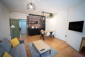 a living room with a couch and a table at Srafko apartment in Subotica