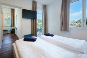 Voodi või voodid majutusasutuse Hotel Paradiso Conca d'Oro toas