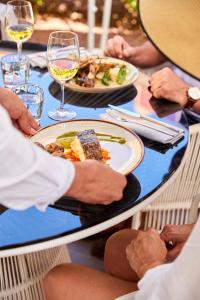 a group of people sitting at a table with a plate of food at Sir Anthony in Playa de las Americas