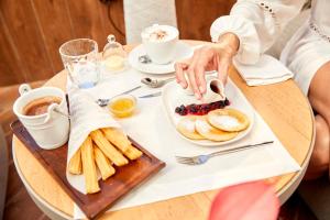 a person sitting at a table with a plate of food at Sir Anthony in Playa de las Americas
