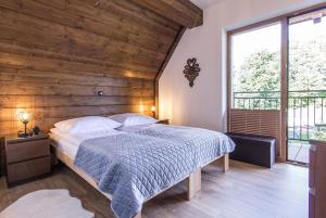 Posteľ alebo postele v izbe v ubytovaní Apartamenty Liptowskie Hale Zakopane
