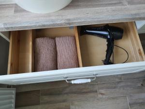 a drawer in a counter with some towels at Marijampolės jaukūs apartamentai in Marijampolė