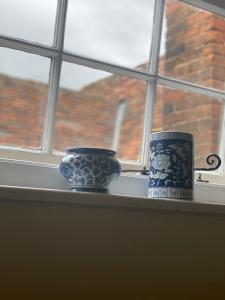 two vases are sitting on a window sill at Fleur De Lys Bed & Breakfast in Dorchester on Thames