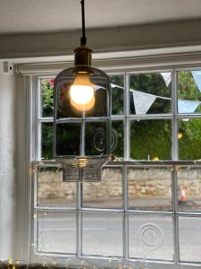 a light hanging in front of a window at Fleur De Lys Bed & Breakfast in Dorchester on Thames