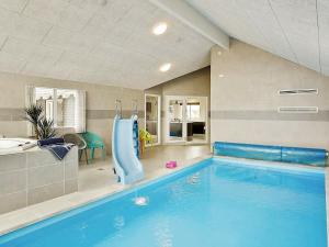 een zwembad met een glijbaan in een huis bij 30 person holiday home in Bogense in Bogense