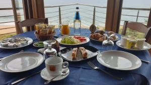 a blue table with plates of food on it at Hotel Corsaro Nero in Portu Maga
