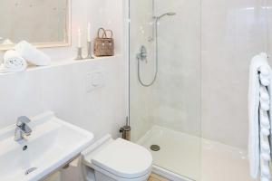 a bathroom with a shower and a toilet and a sink at Carlotta s Beachroom in List