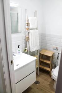 a bathroom with a white sink and a toilet at VV Loft Canteras Gran Playa "by henrypole home" in Las Palmas de Gran Canaria +15 photos