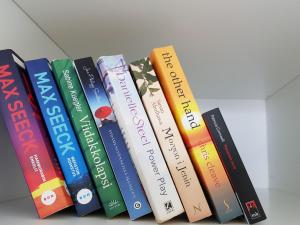 a row of books sitting on a shelf at New studio in West-Pasila in Helsinki