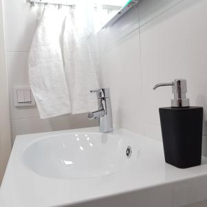 a bathroom with a sink and a faucet at New studio in West-Pasila in Helsinki +4 photos