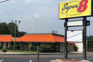a sign for a super restaurant in front of a building at Super 8 by Wyndham Rocky Mount I-95 EXIT 145 in Battleboro