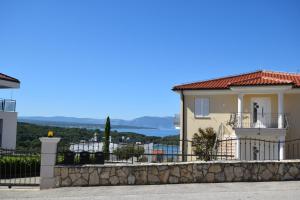 a house with a view of the ocean at Apartments Marjolovic in Njivice