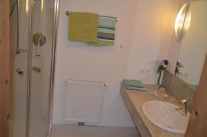a bathroom with a sink and a shower at Pension Kirchbrugger in Telfes im Stubai