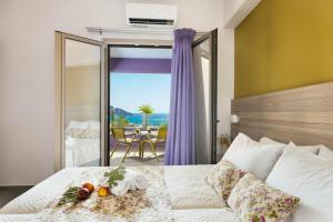 a bedroom with a bed with a view of the ocean at Sea View Luxury Apartments in Plakias