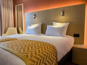 Säng eller sängar i ett rum på Nash Airport Hotel
