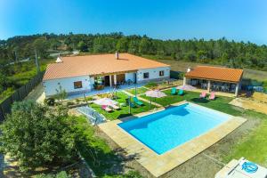 an aerial view of a house with a swimming pool at Montes de Praias GuestHouse in Aljezur