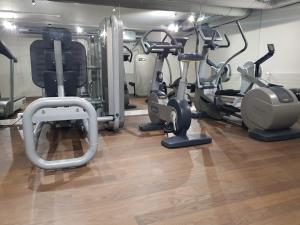 a gym with several exercise bikes and treadmills at Nash Airport Hotel in Geneva