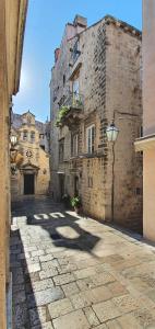 an alley in an old building with a street light at Muziqa Apartments in Dubrovnik