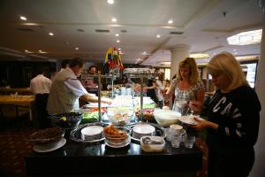 a group of people preparing food at a buffet at Istanbul Royal Hotel in Istanbul