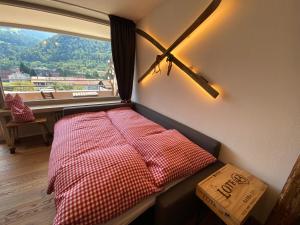 a bed in a room with a large window at HOCH3 Ferienwohnung in Immenstadt im Allgäu