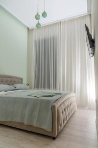 Postel nebo postele na pokoji v ubytování Theasis Athens