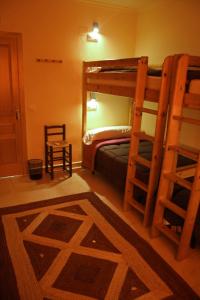 a bedroom with two bunk beds and a rug at Casa Antiquary in Benitachell