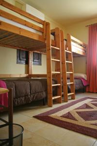 a room with two bunk beds and a couch at Casa Antiquary in Benitachell