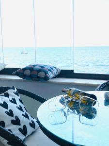 a table with glasses on top of a cruise ship at By Sukru Hotel in Buyukada