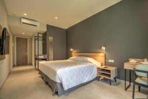 Letto o letti in una camera di Mambruk Hotel & Convention