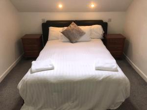 a bedroom with a large white bed with two night stands at Toomullin House Accommodation in Doolin