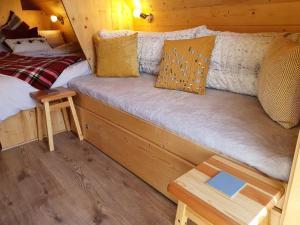 a couch in a cabin with a bed and a table at The Shire in Boston