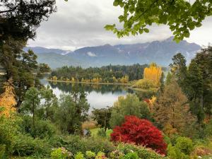 a view of a lake with trees and mountains at Bellevue in San Carlos de Bariloche