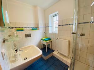 a bathroom with a sink and a shower at Landhaus Hammoor Stieper Gastronomie GmbH in Hammoor +130 photos