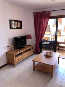 a living room with a television and a coffee table at Apartment Cardon Los Cristianos in Los Cristianos