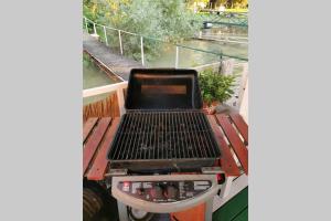 a grill sitting on a table on a deck at En ChillAda River house in Belgrade