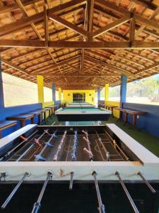 a pool table with paddles in it in a room at Pousada Nefelibatas in Águas de Lindoia