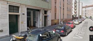 a row of cars parked on the side of a street at Hotel Lucania in Milan