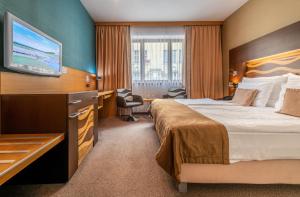 Postel nebo postele na pokoji v ubytování Danubia Gate Hotel