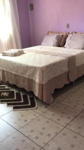 a bed sitting on top of a floor in a room at Pousada Fora de Rota in Colinas Do Sul