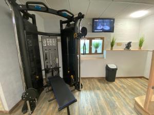 a room with a gym with a treadmill at H&ocirc;tel Bagatelle in Pont-&agrave;-Mousson