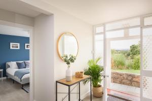 a bedroom with a bed and a mirror at River Retreat Apartment Exeter - River Views & Parking in Exeter