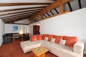 a living room with a couch and a table at T3 Alpenhotel Garfrescha in Sankt Gallenkirch