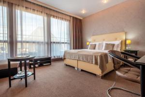 Postel nebo postele na pokoji v ubytování Danubia Gate Hotel