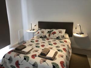 a bed with two lamps and two towels on it at Punta Brava Relax in Puerto de la Cruz