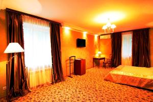 a hotel room with a bed and a window at Britaniya in Kharkiv