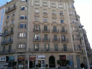 a tall building with balconies on a city street at Ally's Bed&Breakfast, in Barcelona